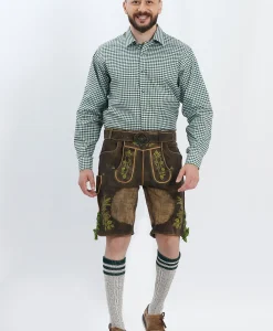 Lederhosen Men in Dark Brown Color with Traditional Embroidery. Model is wearing Green Checkered Traditional Shirt with Bavarian Socks and Shoes.
